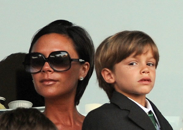 Victoria Beckham and her son Romeo (R) attend the friendly game Los Angeles Galaxy vs Milan AC, in Carson, California on July 19, 2009. AFP PHOTO / GABRIEL BOUYS (Photo credit should read GABRIEL BOUYS/AFP/Getty Images)
